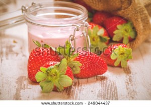 stock-photo-wiosenne-owoce-truskawki-w-lnianym-worku-z-truskawkowym-jogurtem-na-vintage-drewnianym-stole-249044437