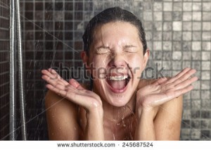 stock-photo-young-woman-reacting-in-shock-to-hot-or-cold-shower-water-as-she-stands-under-the-shower-head-245687524