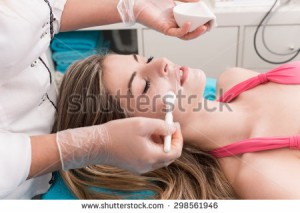 stock-photo-woman-having-a-facial-massage-and-peeling-in-beauty-salon-298561946